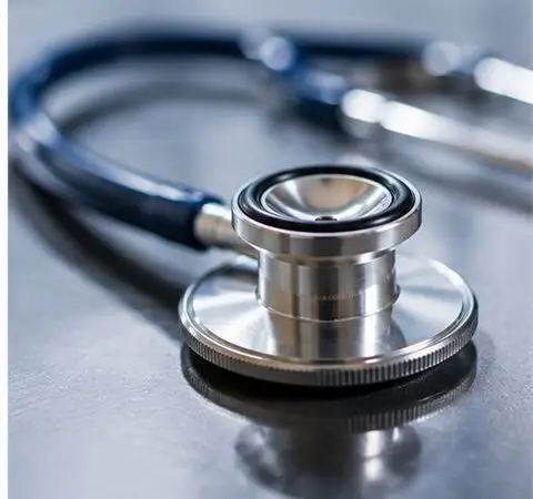 A stethoscope rests on a clinic table.