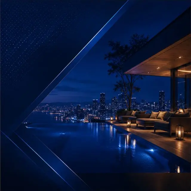 An infinity pool and terrace overlooking a harbour at night.